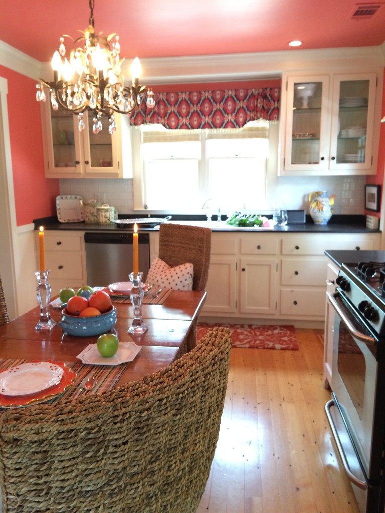 kitchen with white cabinets and coral orange walls ceiling