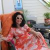 woman lounging on deck with drink