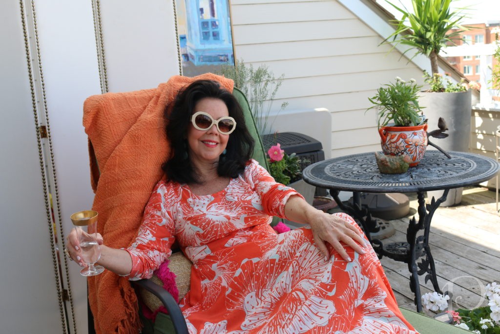 woman lounging on deck with drink