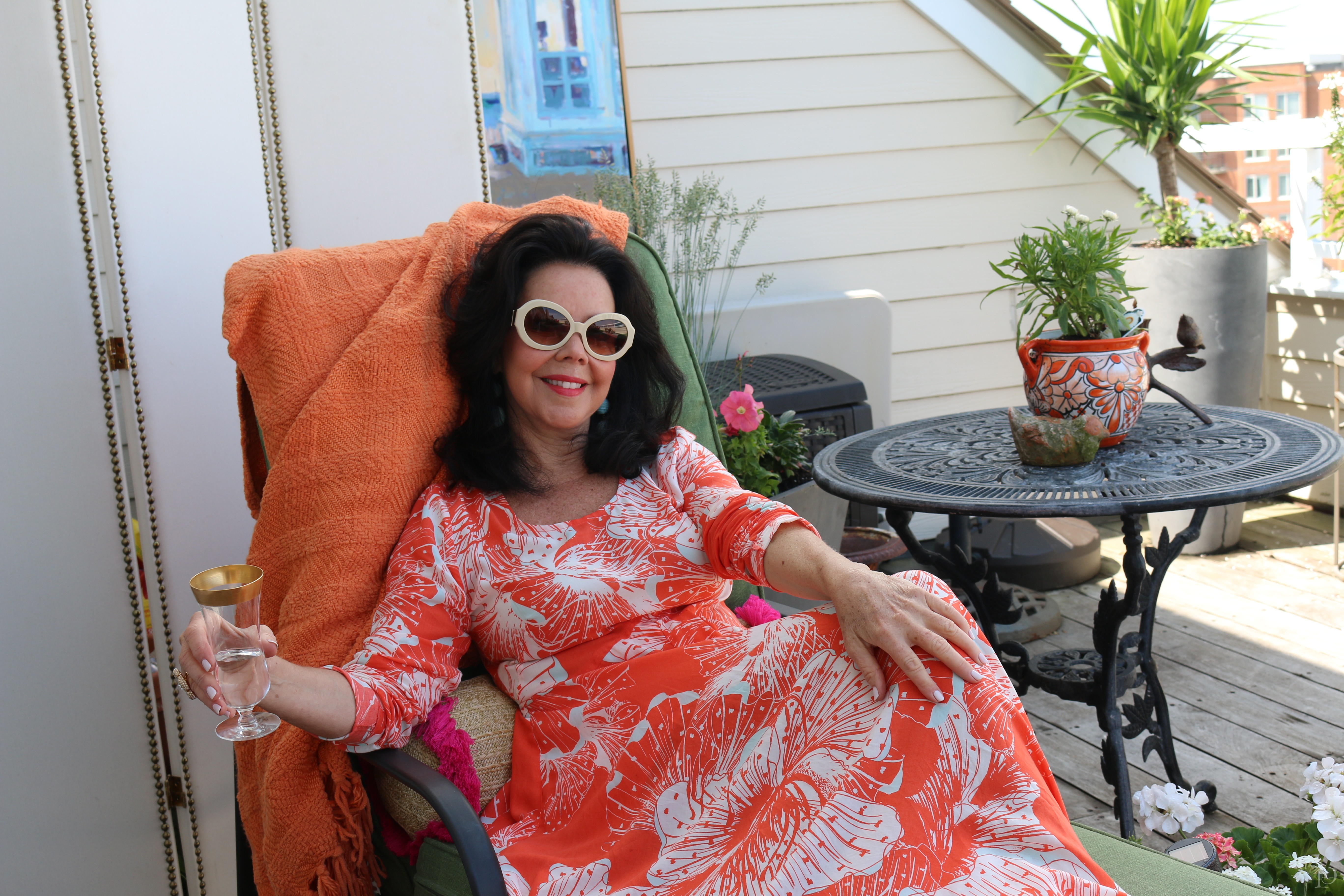 woman lounging on deck with drink